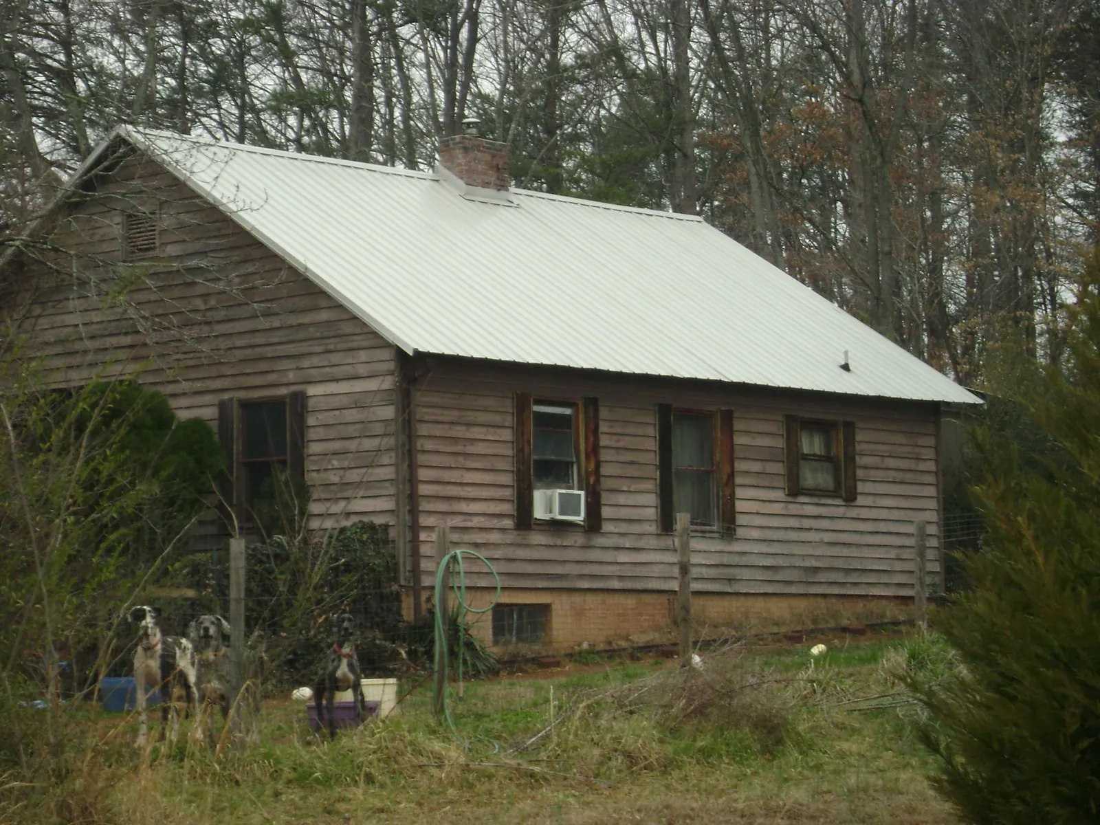 White metal roof on an old wood sided farmhouse, from a Metal Roof Installation job in Warren